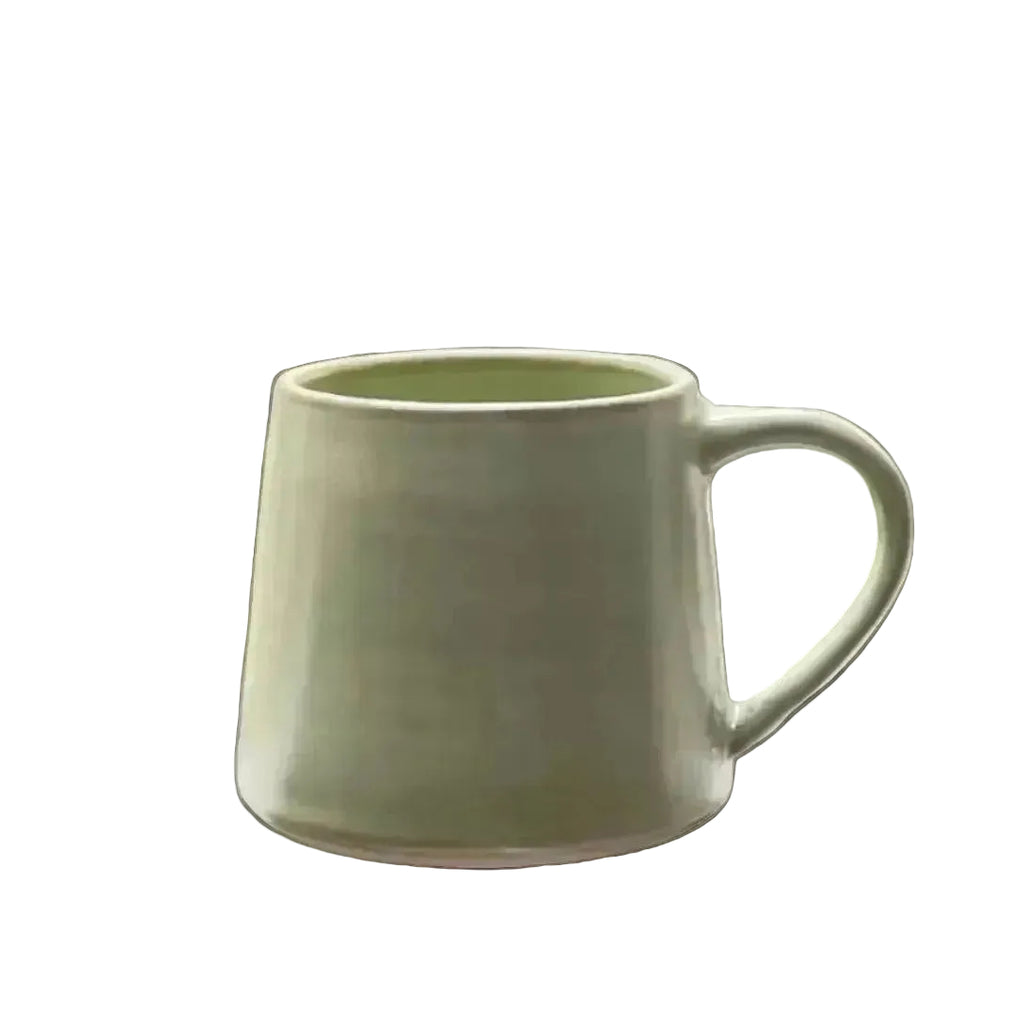 A light green coffee cup with tapered walls and a rounded handle. Cup opening is narrower than the base, creating angled walls. 

Glaze details: light lime green glaze with bown variations where the glaze is thiner, such as on the rim. 
